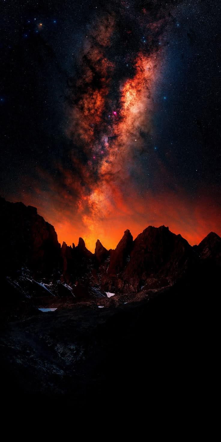 Fiery Milky Way Galaxy Over Mountains Wallpaper